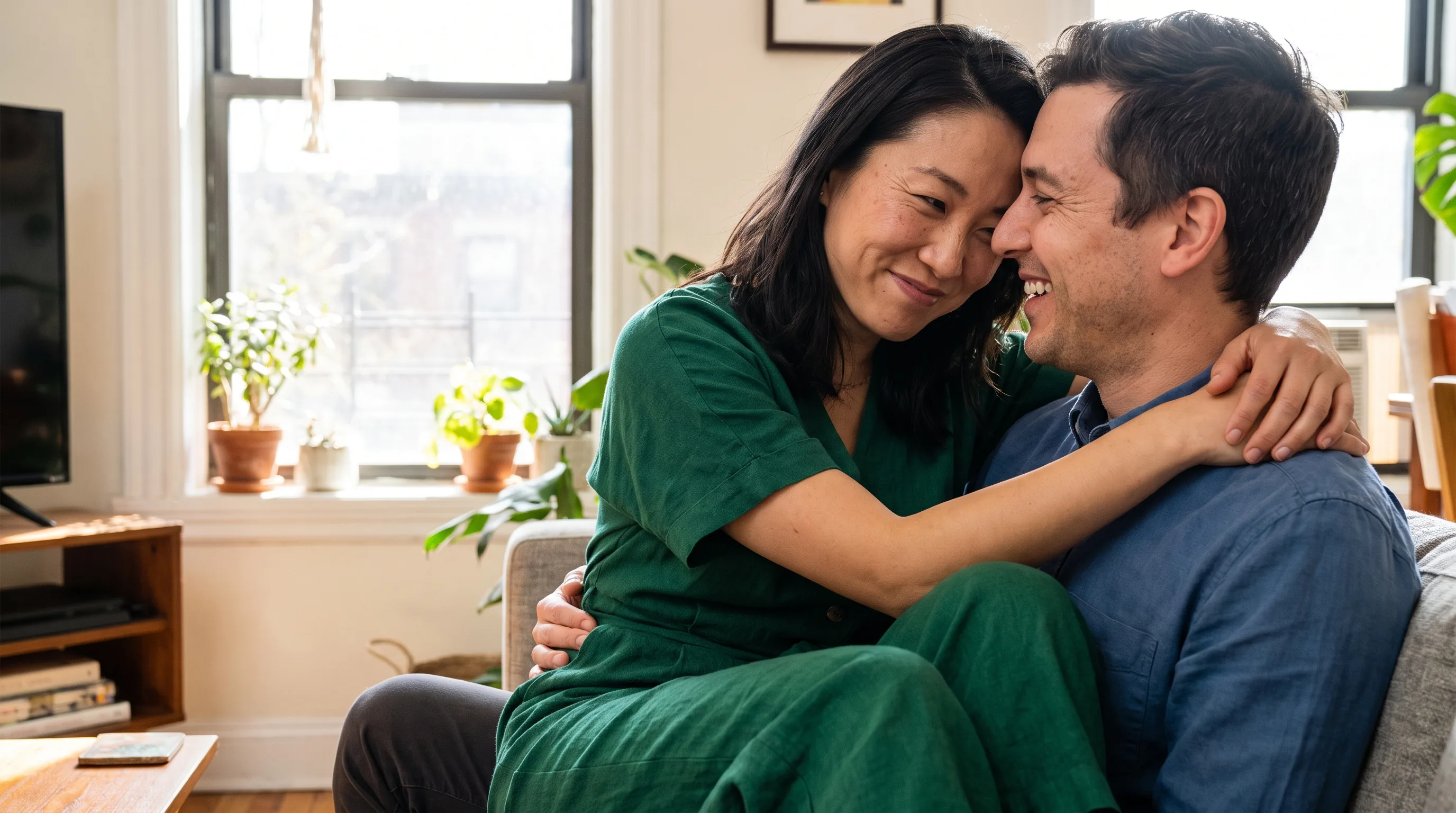 A confident, warm couple sharing a close, relaxed moment together at home, genuine affection and ease