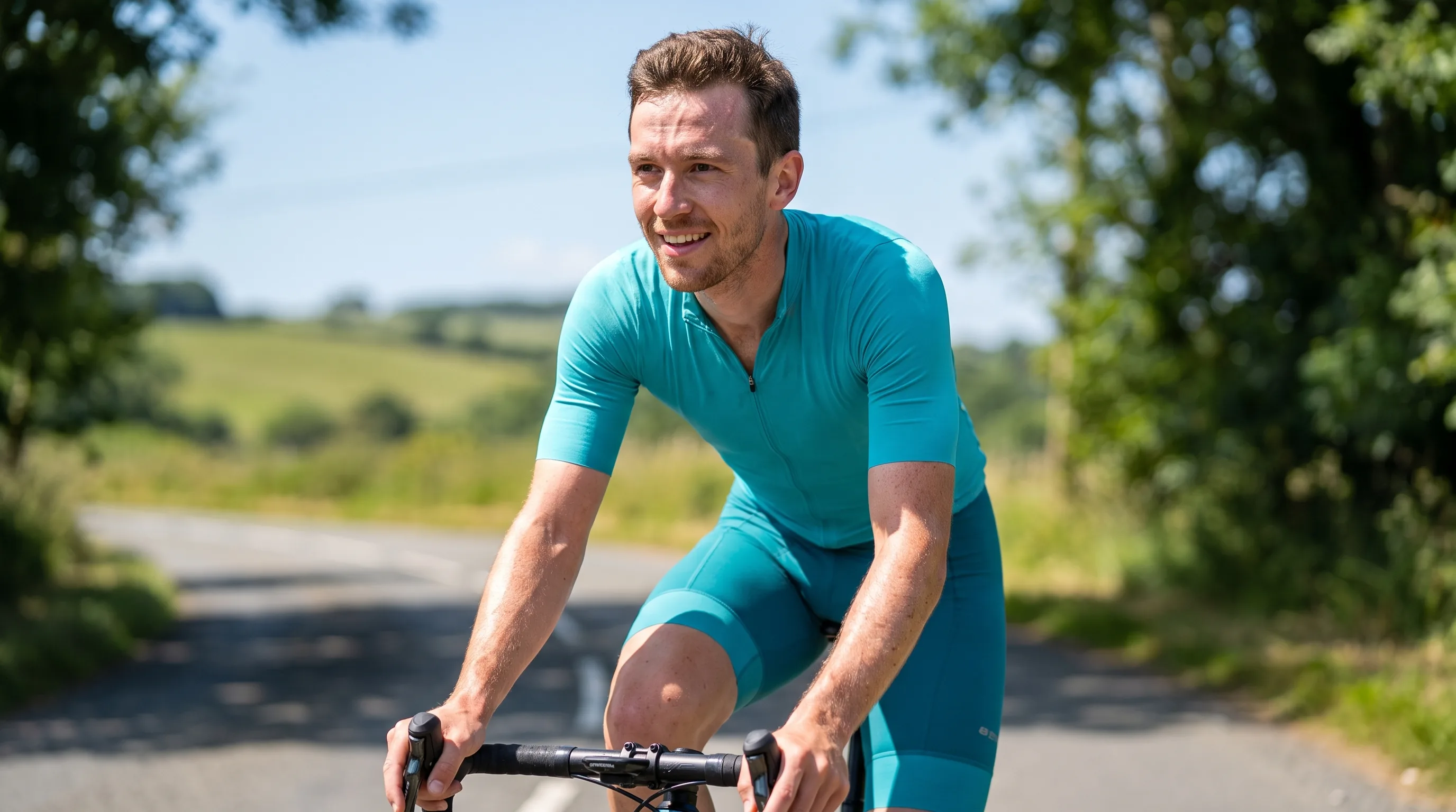 A lean, athletic man in their 20s cycling hard outdoors